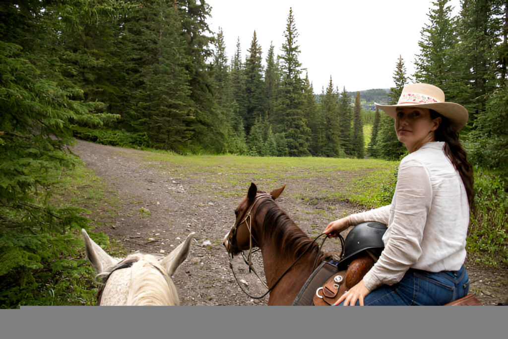 Horse and rider using a lightweight endurance saddle while navigating a trail during an endurance ride.