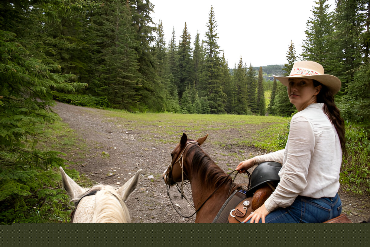 Horse and rider using a lightweight endurance saddle while navigating a trail during an endurance ride.